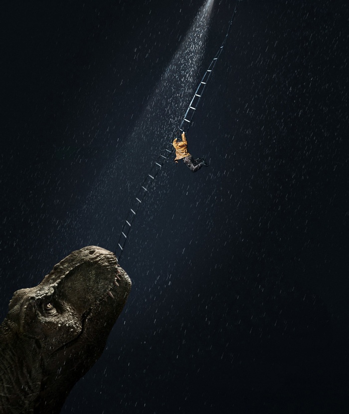 Man climbing ladder near T-Rex in Jurassic World: Fallen Kingdom