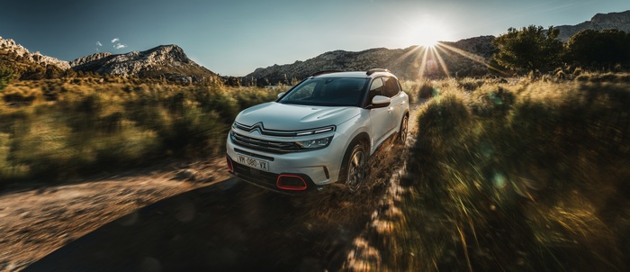 White Citroen C5 Aircross driving on a dirt road