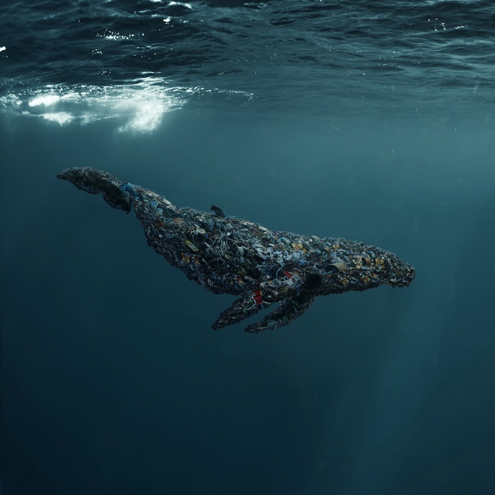 Whale made of trash underwater