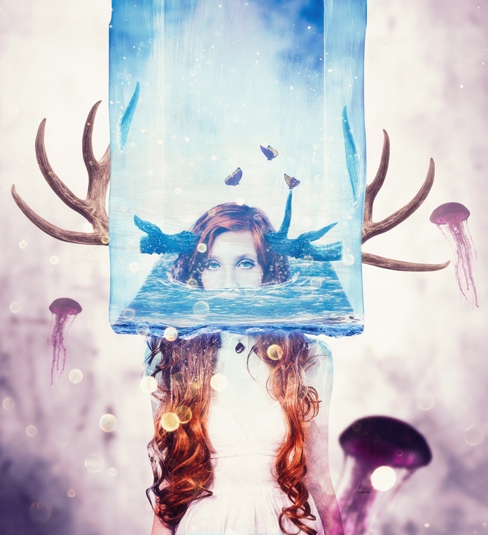 Girl with antlers and jellyfish in water