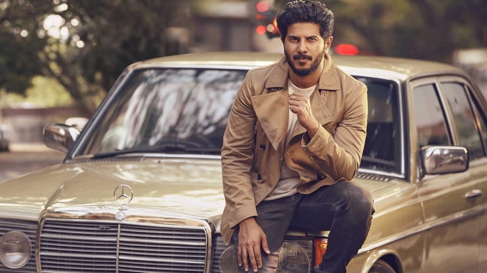 Dulquer Salmaan sitting on a vintage Mercedes-Benz