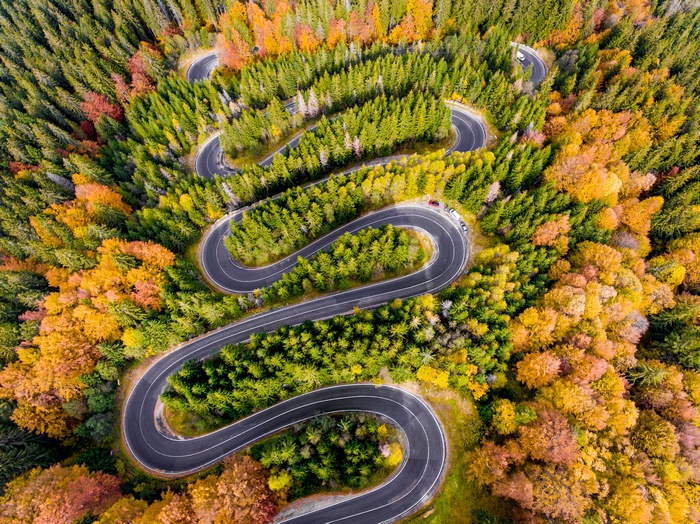 Winding mountain road in Transylvania, Romania during autumn