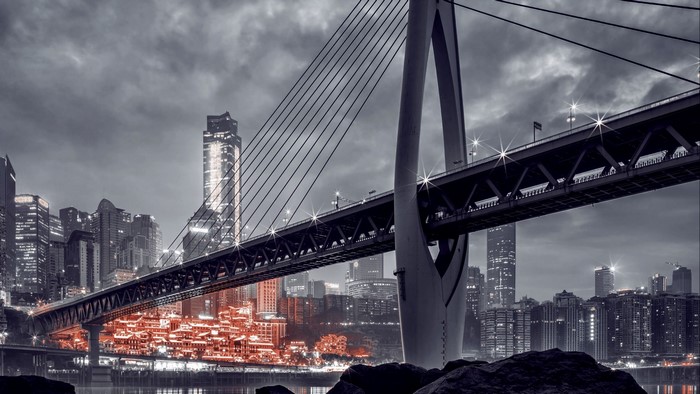 Bridge over a city with illuminated buildings