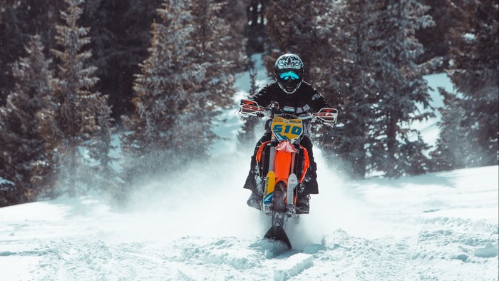 Snowbike Rider in Snowy Forest