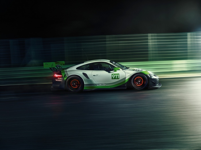 Porsche 911 GT3 R race car on track at night