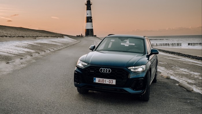 Audi Q5 parked by a lighthouse at sunset