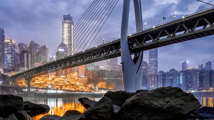 Bridge over river in a city at night