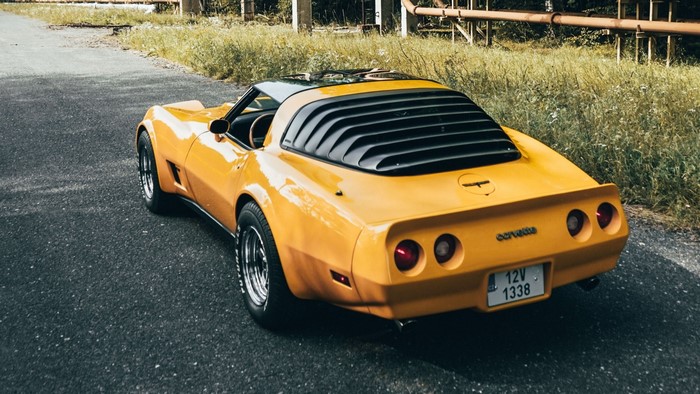 Yellow Corvette Stingray parked on asphalt road