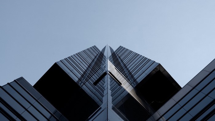 Modern glass skyscraper against a clear sky