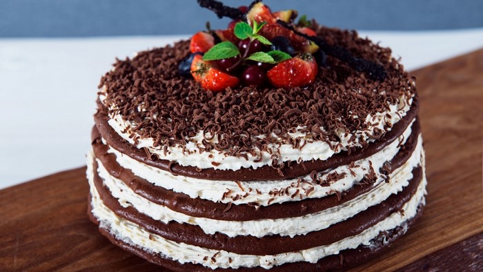 Chocolate layer cake with whipped cream and berries