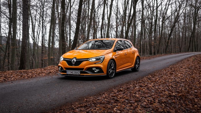 Orange Renault Megane RS on a forest road