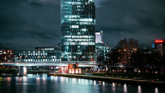 Night cityscape with river and modern buildings