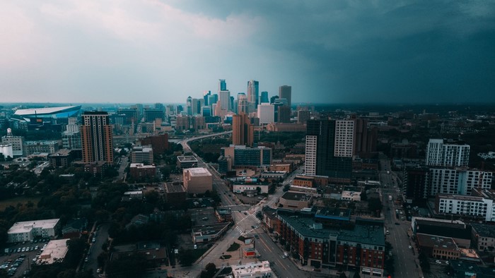 Minneapolis cityscape with stadium and stormy sky