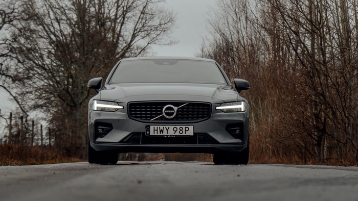 Volvo S60 on a wet road with trees