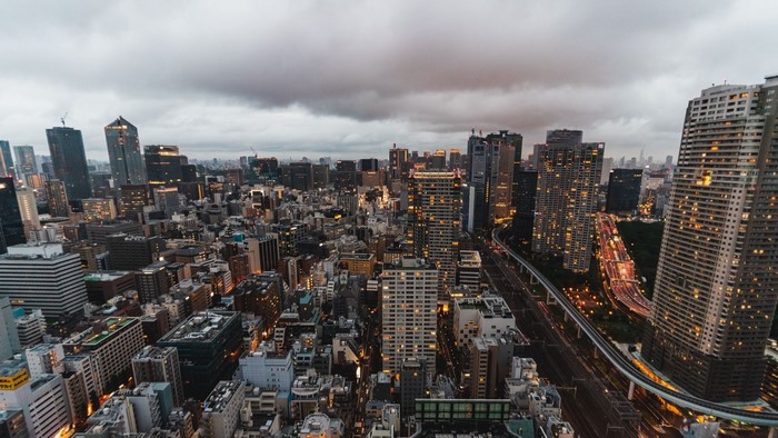 Aerial view of a dense city skyline at dusk