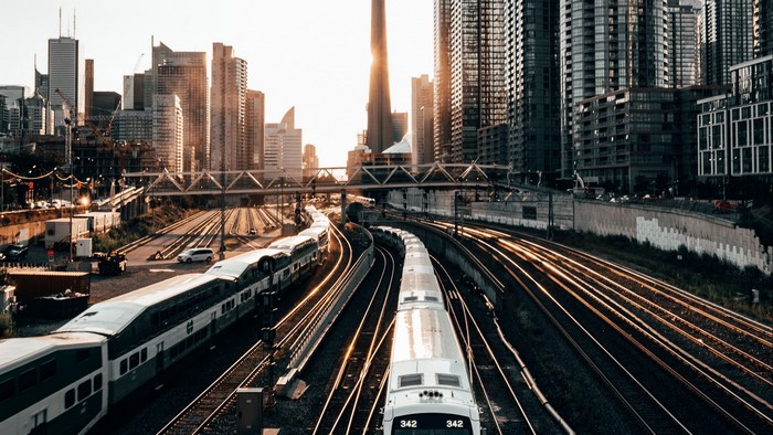 Trains on tracks in a city with skyscrapers