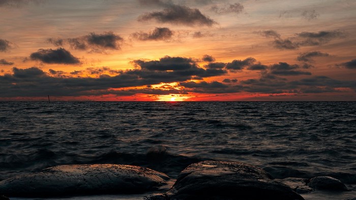 Sunset over the ocean with rocks
