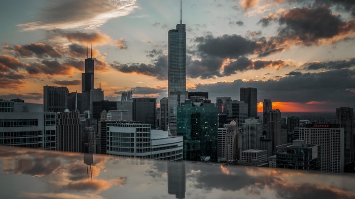Cityscape with skyscrapers and sunset reflection