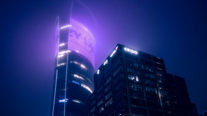 Night city skyscrapers with purple and white lights