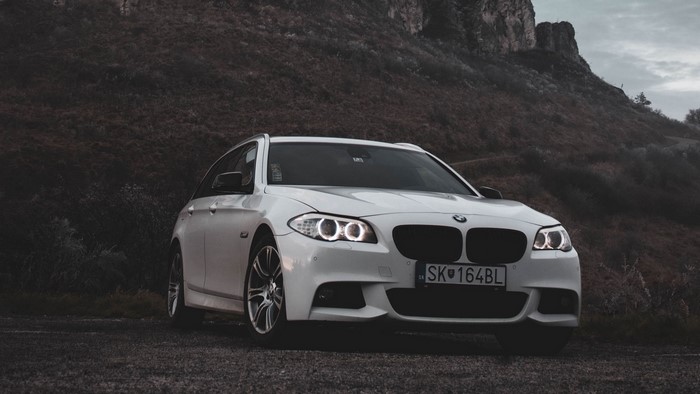 White BMW Station Wagon on a Rocky Hillside