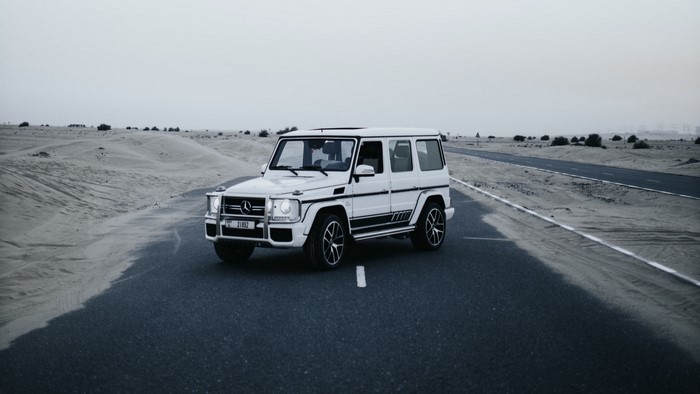 White Mercedes G-Wagon on a Desert Road