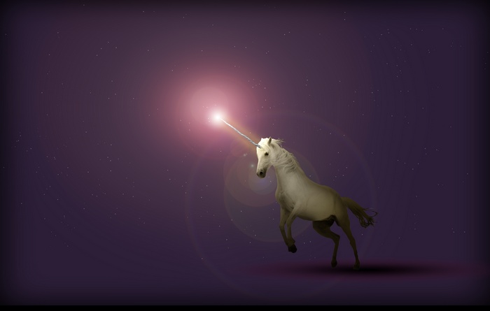Unicorn with glowing horn in starry purple sky
