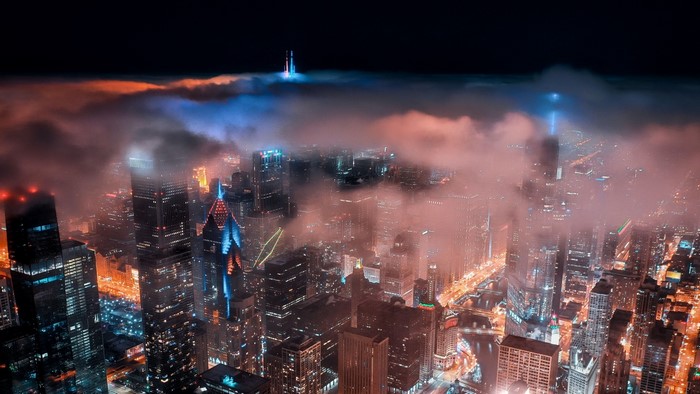Night city skyline with fog and lights