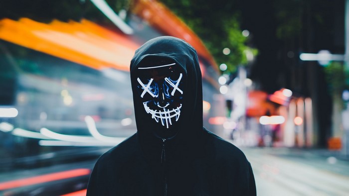 Person in Anonymous mask at night