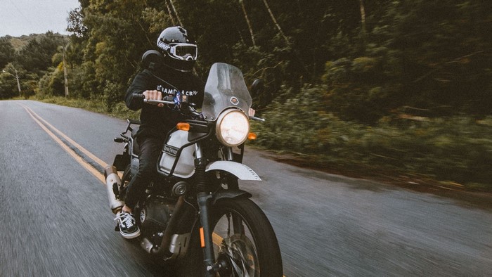 Man riding a Royal Enfield Himalayan motorcycle