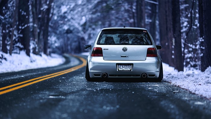 Silver Volkswagen Golf IV R32 on a Snowy Road