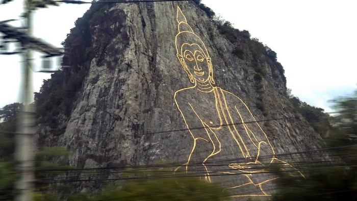 Buddha image carved into a cliff in Thailand