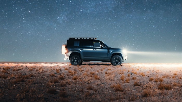 Land Rover Defender under starry sky