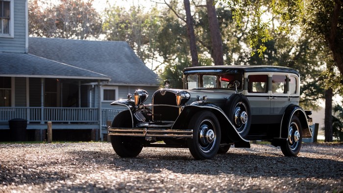 Vintage car parked in front of a house