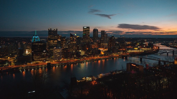 Pittsburgh skyline at dusk with rivers and bridges
