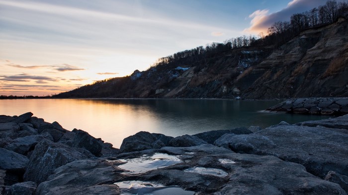 Lake and cliffside at sunset