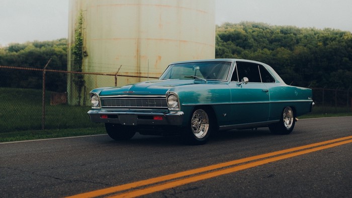Teal vintage Chevrolet Nova parked on a road