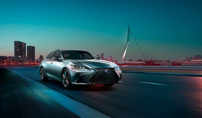 Lexus ES 300h F Sport driving over a bridge at night