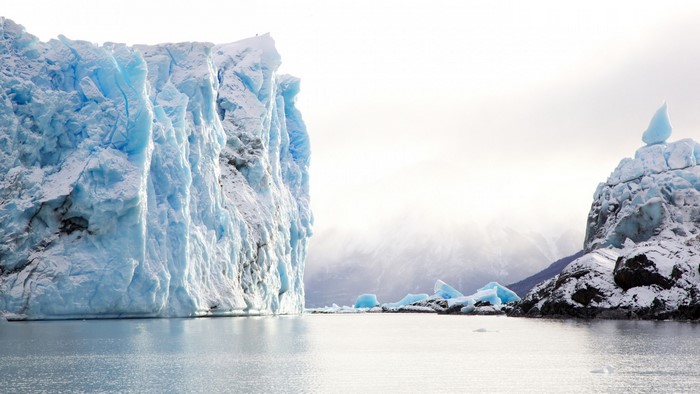 Massive blue iceberg in glacial water