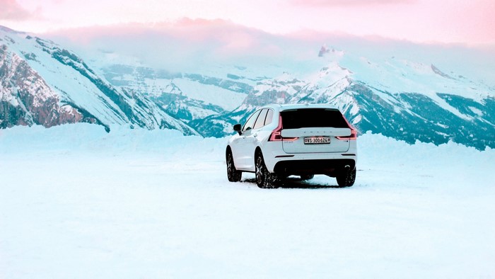 White Volvo XC60 in snowy mountains