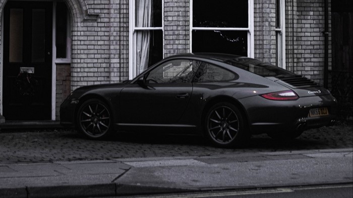 Porsche 911 Carrera S parked in front of a house