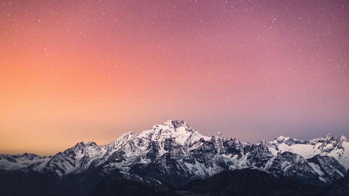 Snow-capped mountains under a starry sky