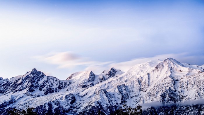 Snow-covered Alps mountains under a blue sky