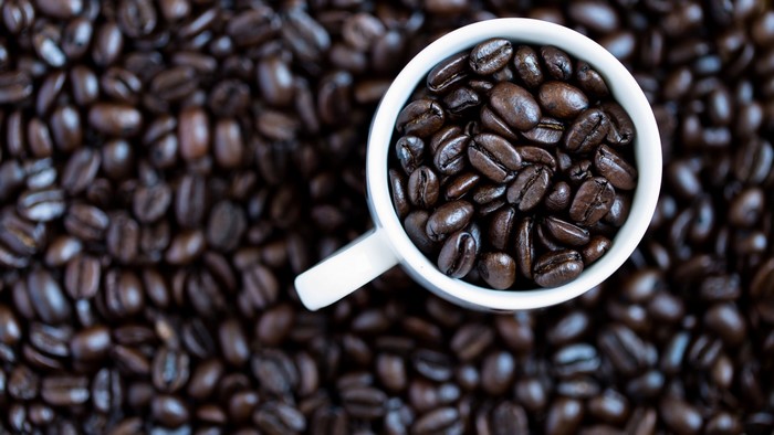 Coffee beans in a white mug