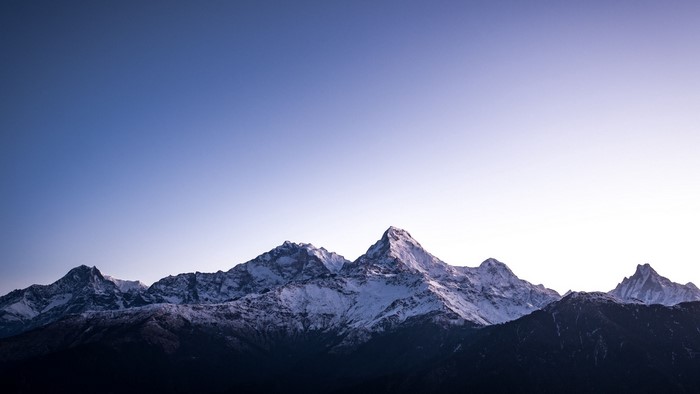 Snow-capped mountains under a clear sky