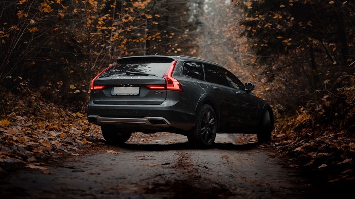 Dark Volvo V90 Cross Country on a forest road