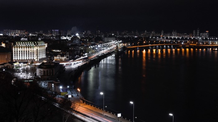 Night cityscape with river and illuminated buildings