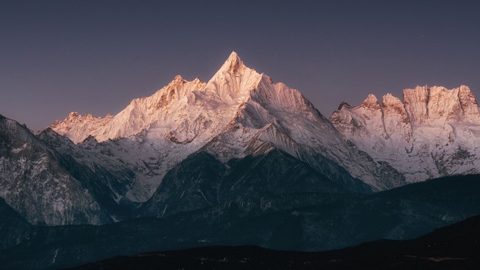 Snow-capped mountains at sunset