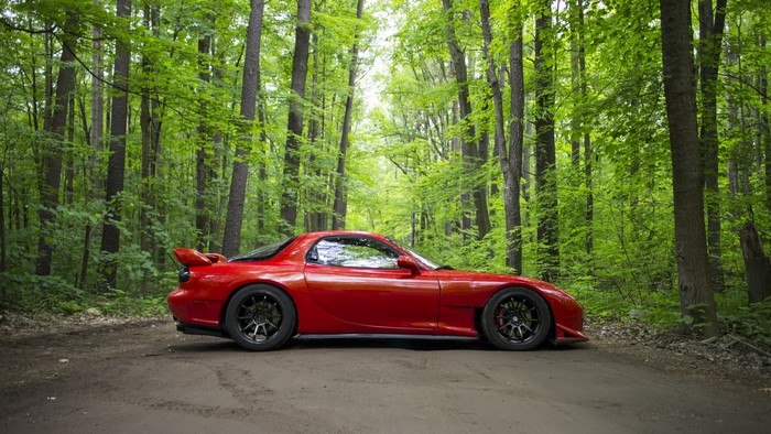 Red Mazda RX-7 in a Forest