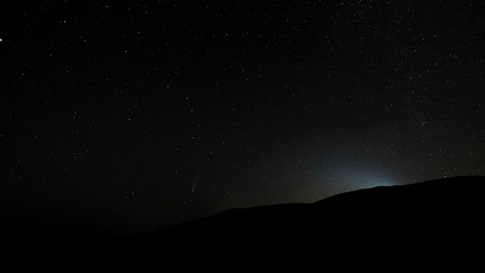 Starry night sky over a silhouetted mountain range