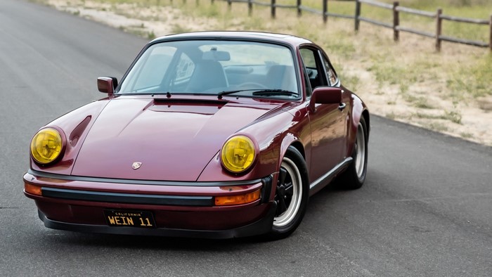 Maroon Porsche 911 SC on a Road